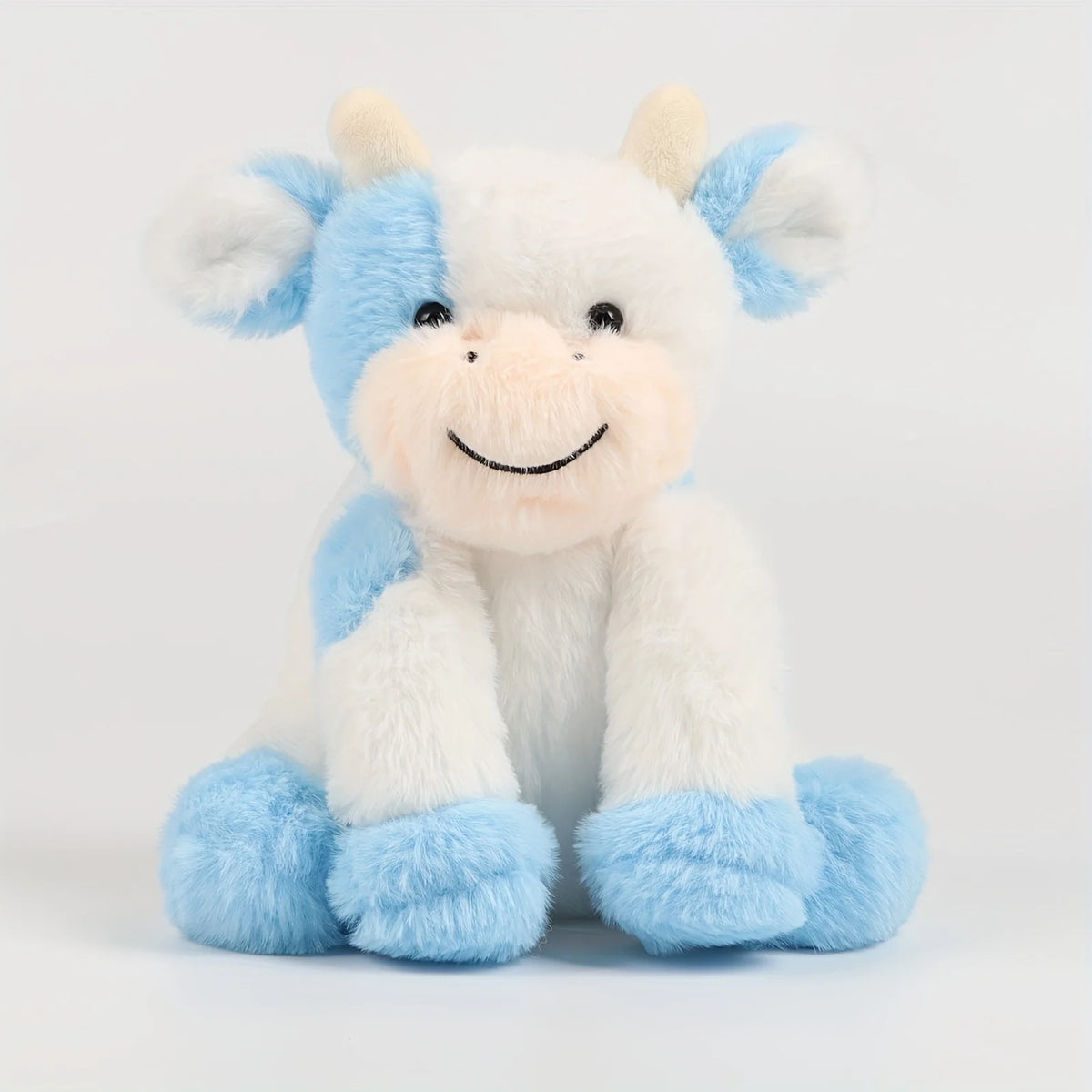 Peluche vache bleue et blanche au grand sourire