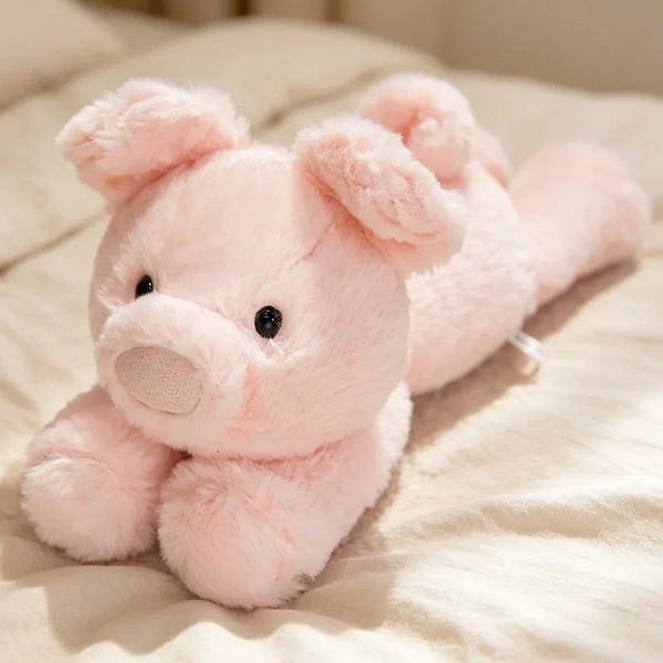 Peluche cochon rose allongée